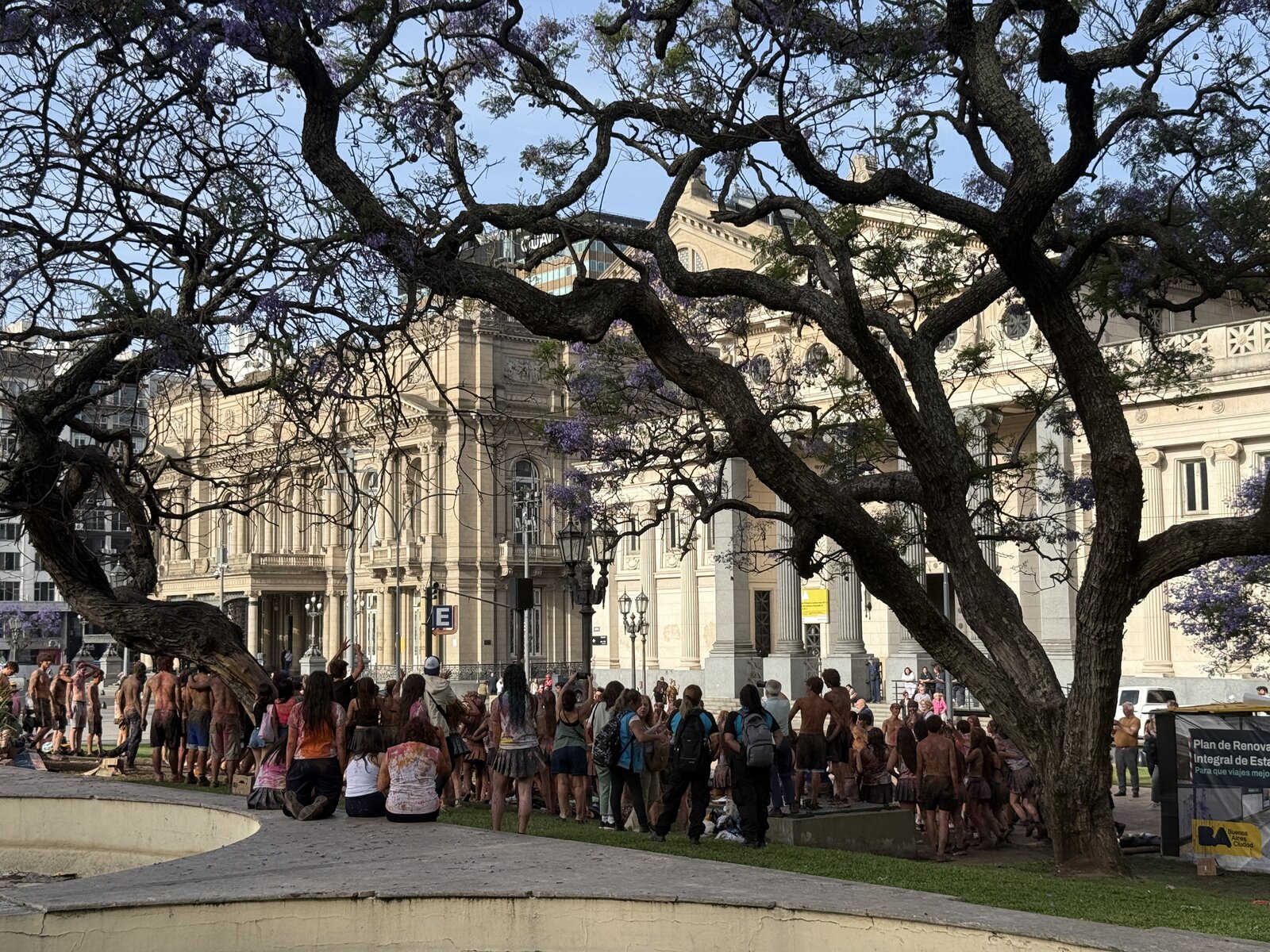 Crowd gathered outside Teatro Colón at golden hour